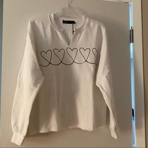 White sweatshirt with black hearts
